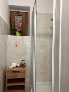 a bathroom with a shower and a wooden table at Casetta al Belvedere - Lake View in Vercana +14 photos