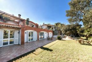 an exterior view of a large house with a yard at Casa del passero - Villa with Infinity Garden and Sea View in Forio d'Ischia