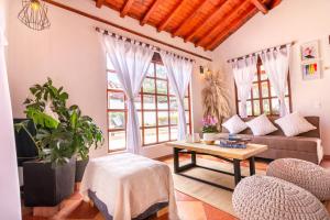 a living room with a couch and a table at Condominio The monkey House in Villa de Leyva +53 photos