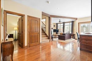 an open living room with a staircase and a living room at House On The Golf La Bte -10min To Tremblant 150 in Mont-Tremblant