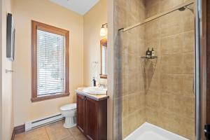 a bathroom with a shower and a toilet and a sink at House On The Golf La Bte -10min To Tremblant 150 in Mont-Tremblant