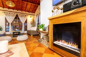 a fireplace in a living room with a couch at Condominio The monkey House in Villa de Leyva