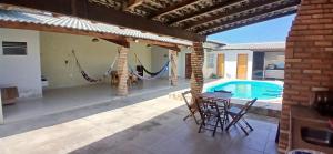 a patio with a hammock and a swimming pool at Casa Parnaíba in Parnaíba