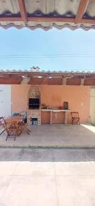 a patio with a table and a brick fireplace at Casa Parnaíba in Parnaíba