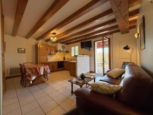 a living room with a couch and a kitchen at Aguerrea in Macaye