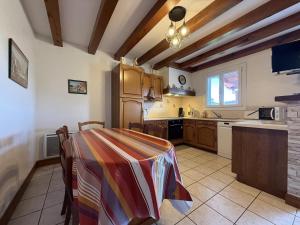 a kitchen with a table with a colorful blanket on it at Aguerrea in Macaye