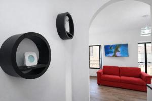 a living room with a red couch and a mirror at Casa Antonelli in Ghemme +63 photos