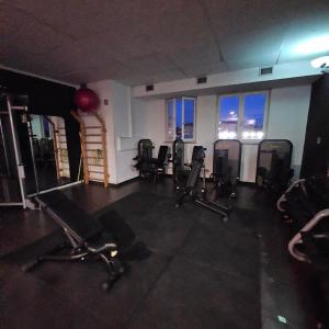 a gym with a row of chairs in a room at b apartments in Case Bruciate