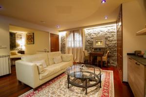 a living room with a white couch and a glass table at HOTEL EL Alboroque in Tramacastilla de Tena