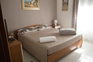 a bedroom with a bed with two pillows on it at villa mediterranea in Realmonte