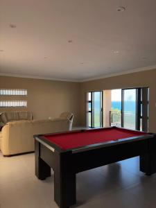 a living room with a pool table and a couch at Oceanview Oasis in Freeland Park