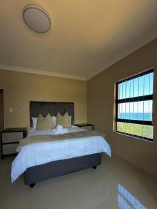 a bedroom with a large bed and a window at Oceanview Oasis in Freeland Park