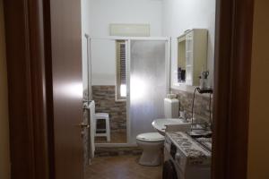a bathroom with a toilet and a sink and a shower at villa mediterranea in Realmonte