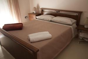 a bedroom with a bed with two towels on it at villa mediterranea in Realmonte +10 photos