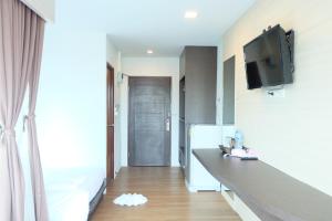 a small kitchen with a counter and a refrigerator at A Plus Deluxe Hotel in Ko Lipe