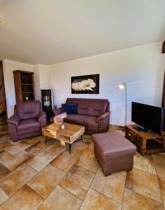 a living room with two couches and a tv at Strandstr_ in Zingst