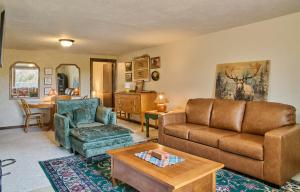 a living room with a couch and a chair and a table at Milner Pass Cabin Retreat in South Fork