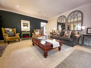a living room with a couch and a coffee table at Shepherd's Corner Guest House - Tranquil Boutique Stay in Bryanston in Johannesburg