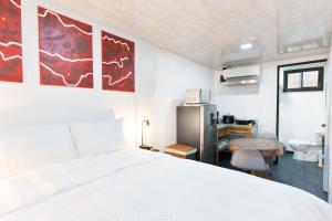 a bedroom with a white bed and a desk at Pura Vida Rent in Nosara
