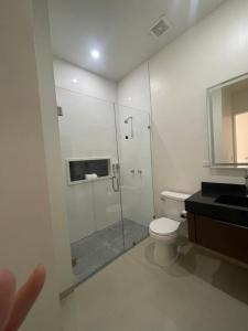a bathroom with a shower and a toilet and a sink at LOFT 3 Tulum in Mexicali +18 photos