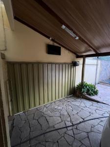 a building with a fence and a tv on the wall at Pousada Gaivota in Trindade
