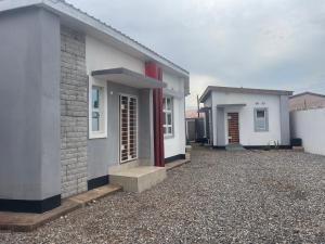 a row of houses sitting on top of a gravel yard at Fusion Apartments in Lusaka