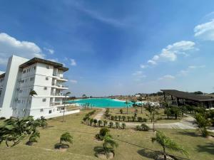 a building with a swimming pool next to a resort at Nerea-Casa de Playa en Condominio Mar Adentro in Naranjalito