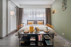 a bedroom with a bed and a table with books at A Beloeil, On Vous Acceuille in Beloeil