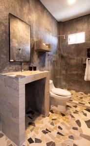 a bathroom with a sink and a toilet and a shower at Casa Pola in Malucano