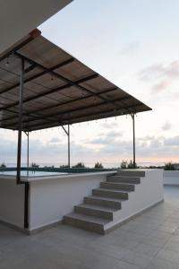 a large building with stairs and a roof at Casa Pola in Malucano