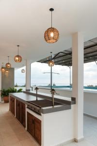 a kitchen with a sink and a counter with windows at Casa Pola in Malucano