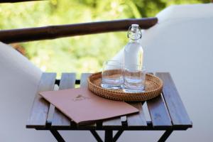 a bottle of water and a book on a wooden table at Casa Pola in Malucano +17 photos