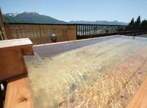 a swimming pool on top of a wooden deck at Hotel Kinomezaka in Minami Uonuma