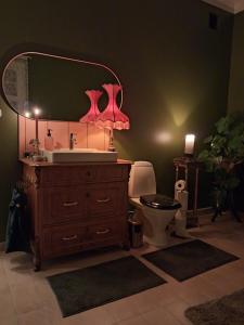 a bathroom with a sink and a toilet with a mirror at Private floor in Molkom