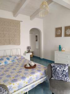 a bedroom with a bed and a chair at Sanacore - Maratea - Cersuta in Maratea