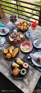 a table with many plates of food on it at Caixa D'aço Exclusive Hotel in Porto Belo