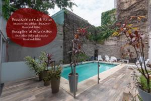 a swimming pool in a building with plants at Syrah Studios in Buenos Aires