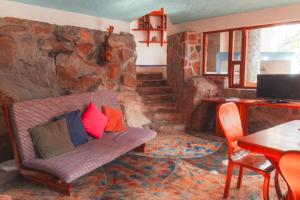 a living room with a couch with pillows on it at El encinal in San Miguel