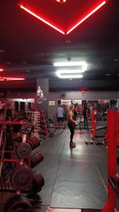 a group of people in a gym with dumbbells at Niv's Hotel in Monte Sião
