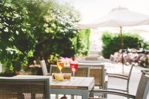 two glasses of wine are sitting on a table at Hotel Marco in Lido di Savio