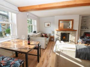 a living room with a table and a fireplace at Hillside View in Hawes