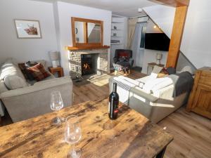 a living room with wine glasses on a wooden table at Hillside View in Hawes