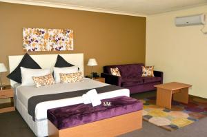 a hotel room with a bed and a couch at Hunts Hotel Liverpool in Liverpool +63 photos