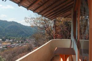 a table on a balcony with a view of a city at El encinal in San Miguel
