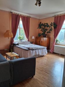 a bedroom with a bed and a couch at Private floor in Molkom