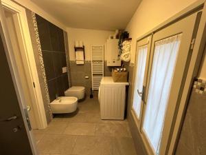 a bathroom with a toilet and a sink at Maison Cavallino in Lugo +5 photos