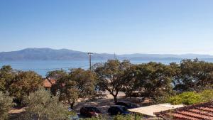 a view of the water with trees and houses at Sivrice Sarnıç in Behramkale