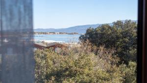 a view of a beach from a window at Sivrice Sarnıç in Behramkale