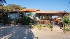 a small house with a porch and a patio at Sivrice Sarnıç in Behramkale