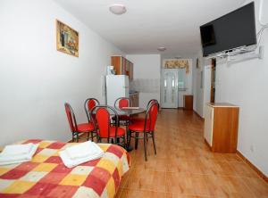 a room with a table and chairs and a kitchen at Golden Coast Villa Caska in Novalja